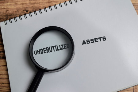 Concept of underutilized assets write on book isolated on Wooden Table.の写真素材