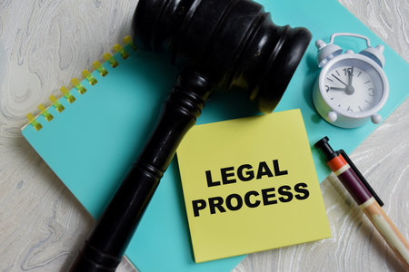 Concept of legal process write on sticky notes isolated on Wooden Table. Representing court...