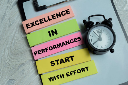 Concept of excellence in performances start with effort write on sticky notes isolated on Wooden Table. For time management motivation and professional growthの写真素材