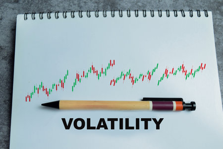 Concept of market volatility write on book with isolated on Wooden Table. For stock market...