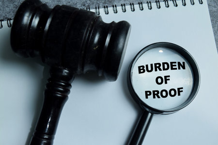Concept of burden of proof write on book with isolated on Wooden Table. Showing legal...