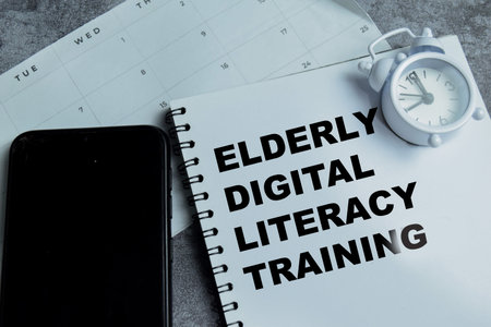 Concept of elderly digital literacy training write on book with isolated on Wooden Table. For senior...