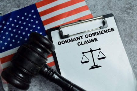 Concept of dormant commerce clause write on clipboard isolated on Wooden Table. Interpretation in...