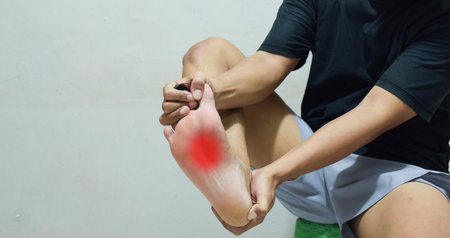 Man suffering from feet ache, foot pain, corns calluses, dry skin on legs. Health problems concept