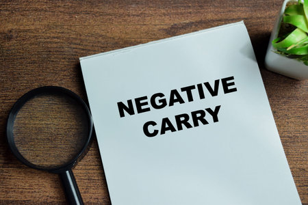 Concept of negative carry write on book isolated on Wooden Table.の写真素材