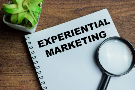 Concept of experiential marketing write on book isolated on Wooden Table.