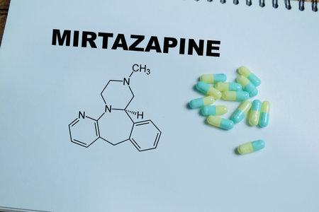 Concept of antidepressant medication write on book isolated on Wooden Table. Treatment of...