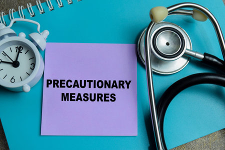 Concept of precautionary measures write on sticky notes isolated on Wooden Table.
