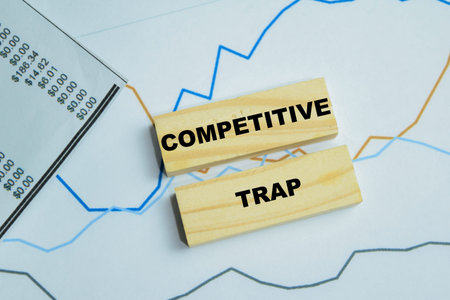 Concept of competitive trap text on wooden blocks.