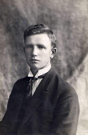 LITHUANIA - CIRCA 1920: A vintage wardrobe card shows a portrait of a young man. Photo was taken in a photographic studio.のeditorial素材