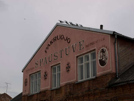 Pakruojis, LITHUANIA - MAY 1,2010 - Sculptures of birds on the roof of the house.のeditorial素材