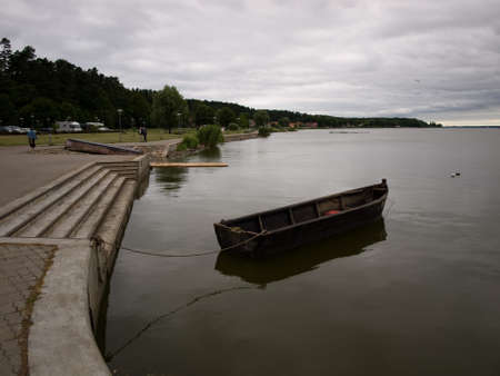 Juodkrante, Lithuania - July 25, 2010 - The boat is moored to the pier.のeditorial素材