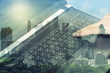 double exposure of press enter button on laptop and cityscape - can use to display or montage on product or concept developmentの写真素材