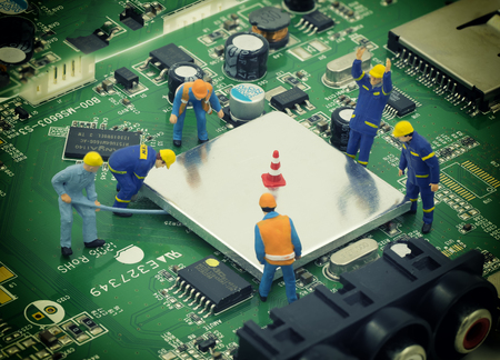 group of mini mechanic work on mainboard and CPU , they try to open chip for repair - can use to...