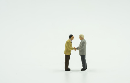 two mini businessman shake hand on isolate background - can use to display or montage on products