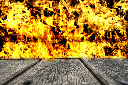 wood table top on blur  fire frame background - can use to display or montage on your productの写真素材