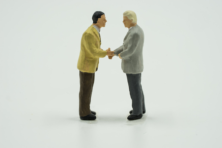 mini businessman talking and commit on isolate - can use to display or montage on productの写真素材