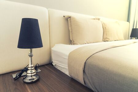 abstract lamp on head of bed in bedroom with vintage filter - can use to display or montage on productの写真素材