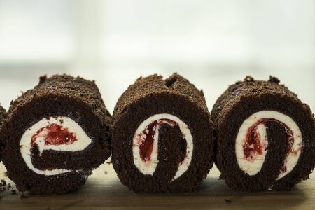 three black forest cake roll face cut on wood - can use to display or montage on product