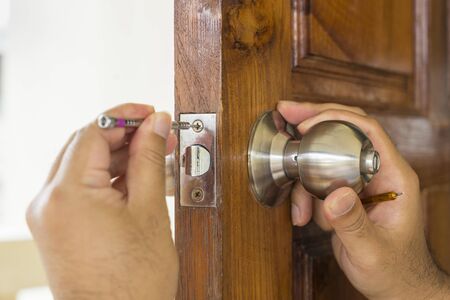 locksmith repair the wood door by screwdriver - can use to display or montage on product