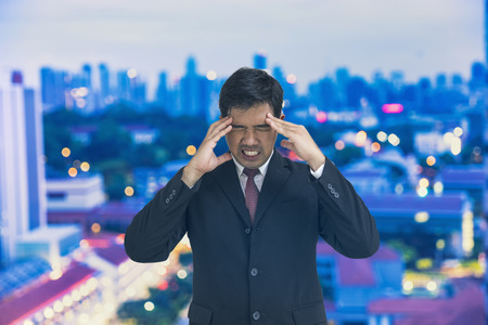 scene of businessman headache on cityscape bokeh background - can use to display or montage productの写真素材