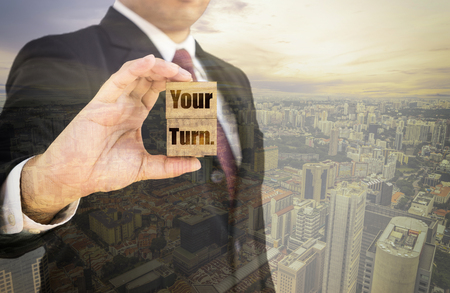 double exposure of businessman show word your turn on wood block and cityscape - can use to display or montage on productの写真素材