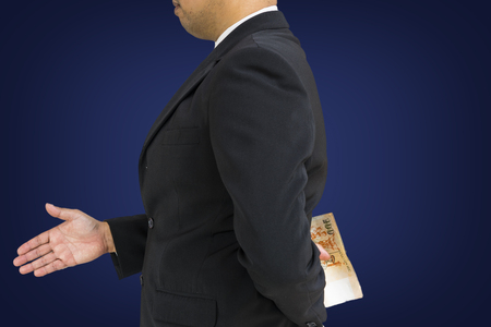 scene of corruption concept from businessman and money behind welcome hand shaking isolate - can use to display or montage on productの写真素材