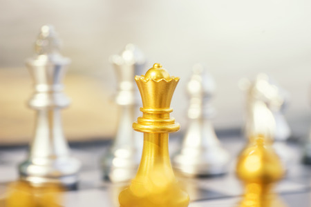 abstract queen gold chess on silver group , focus on gold queen - can use to display or montage on productの写真素材
