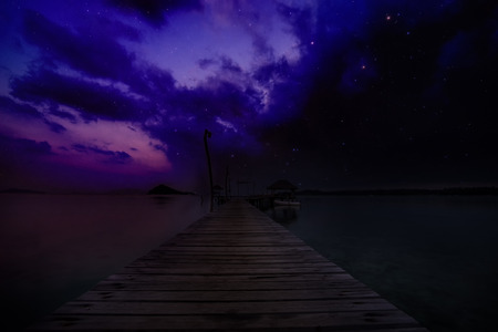 abstract ocean dock in the sea and milky way on sky in early moring - can use to display or montage on productの写真素材