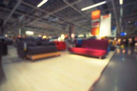 abstract blur background of sofa store and bokeh light on vintage filter - can use to display or montage on productの写真素材
