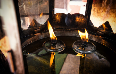 frame of fire in lamp and oil candle , Buddhist templeの写真素材