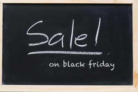 sale sign on black friday on black chalkboard to enjoy your shopingの写真素材