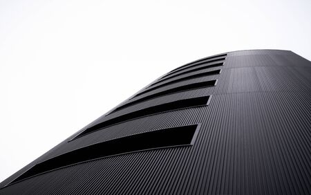 bottom up view of perspective pattern line building with clear white sky backgroundの写真素材