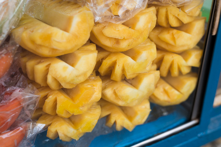 Pineapple slices in glass cabinet at marketの写真素材
