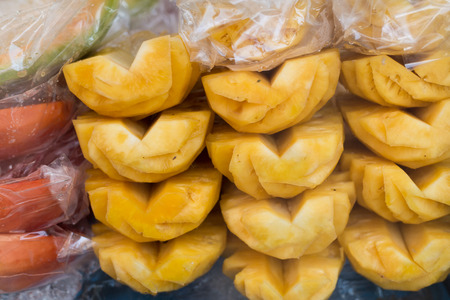 Pineapple slices in front view at marketの写真素材