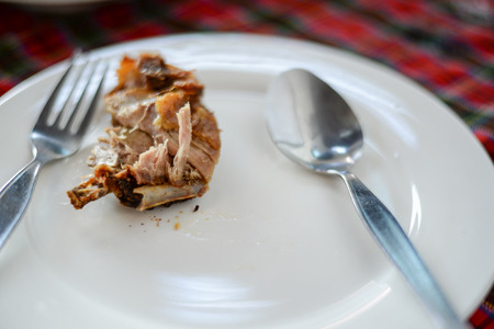 A meat slices on dish with spoon and forkの写真素材
