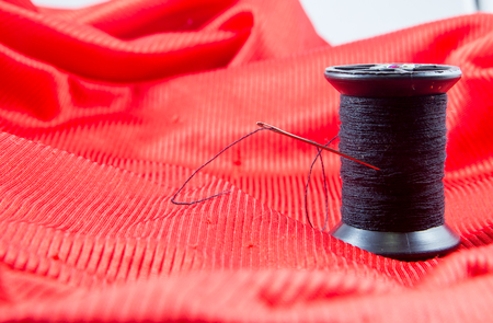 black thread on red fabric