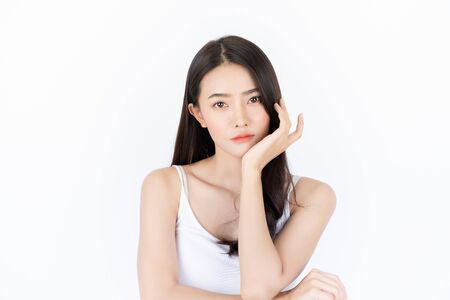 Young asian woman has smiling face and bright skin tone.Asian woman standing with isolated white background.の写真素材