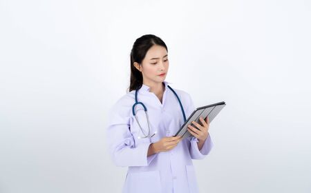 Doctor wearing white gown with a stethoscope on her neck.の写真素材