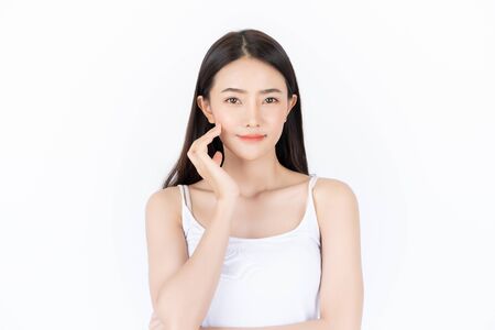 Young asian woman has smiling face and bright skin tone.Asian woman standing with isolated white background.の写真素材