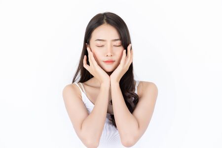 Young asian woman has smiling face and bright skin tone.Asian woman standing with isolated white background.の写真素材