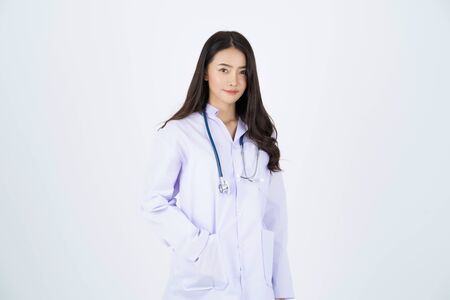 Doctor wearing white gown with a stethoscope on her neck.の写真素材