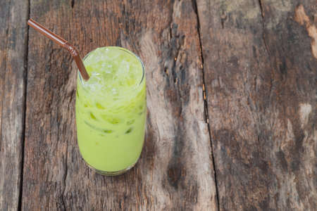 Cup of Green tea lateral view on old woodの写真素材