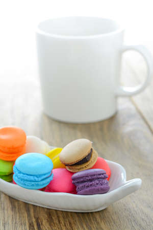 Colorful Macarons and coffee cup on wood tableの写真素材