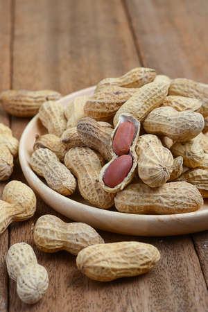 Close up of roasted peanuts on wooden tableの写真素材