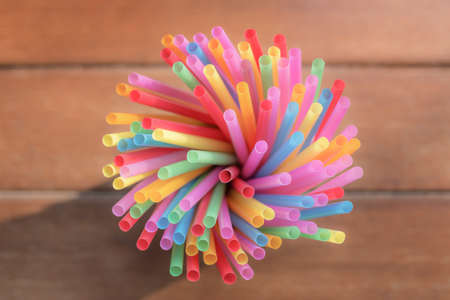 colored drinking straws with nature background - close up