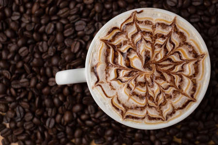 Cup of coffee on coffee beans background.の写真素材