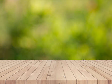 wooden deck table with green blurred background.の写真素材
