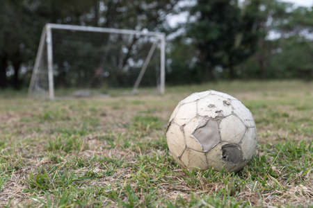 Old soccer ball on fieldの写真素材