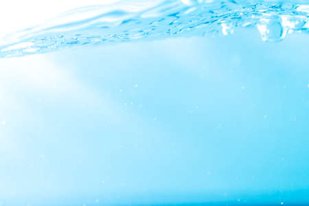 Water wave with bubble of air, on white background. Blue waterの写真素材